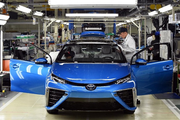 Employees of Toyota Motors check the FCV "Mirai" on its final assembly line during the vehicle's line off ceremony at the Motomachi factory in Toyota city, Aichi prefecture on February 24, 2015. PHOTO: AFP