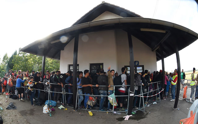 Migrants are waiting to board a bus at the train station in Nickelsdorf, Austria near the Hungarian-Austrian border on September 10, 2015. Since the beginning of 2015. PHOTO: AFP