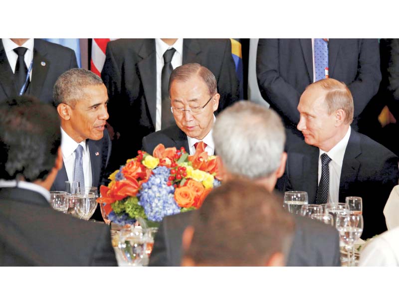 Barack Obama, Ban Ki-moon and Vladimir Putin speak over lunch at the UN headquarters. PHOTO: REUTERS
