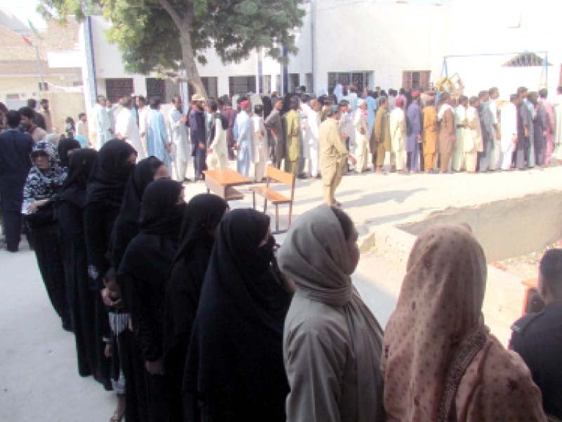 People line up outside a polling station in Government Girl’s Primary School, Sukkur, to cast their votes in the first phase of the LG elections that took place in eight districts of upper Sindh on Saturday. PHOTO: NAEEM AHMED GHOURI/EXPRESS