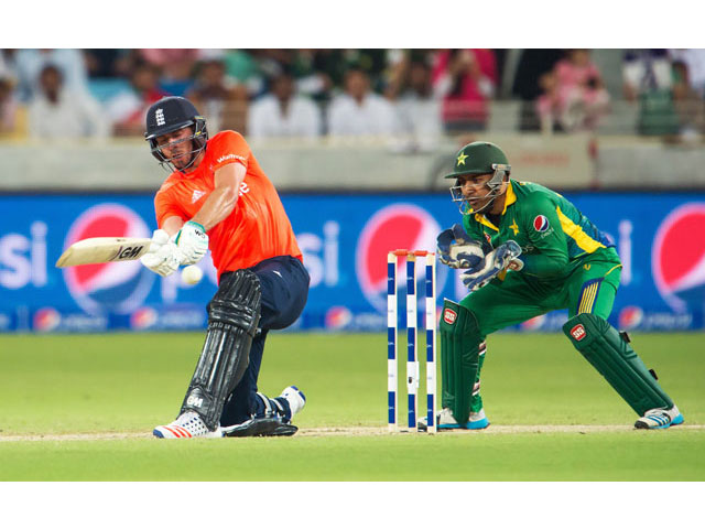England's James Vince (L) plays a shot while Pakistan's wicket keeper Sarfraz Ahmed watches during the second T20 cricket match between Pakistan and England at the Dubai International Cricket Stadium in Dubai on November 27, 2015. PHOTO: AFP