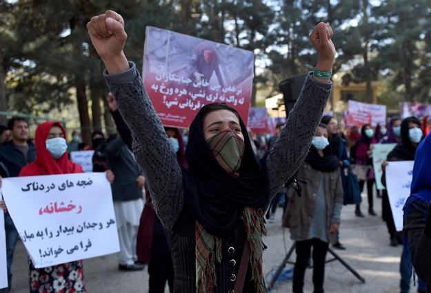 Afghan Solidarity members hold posters and chant slogans as they stage a protest against Taliban militants who stoned an Afghan woman to death, at Shar-e-Naw Park in Kabul on November 6, 2015. PHOTO: AFP