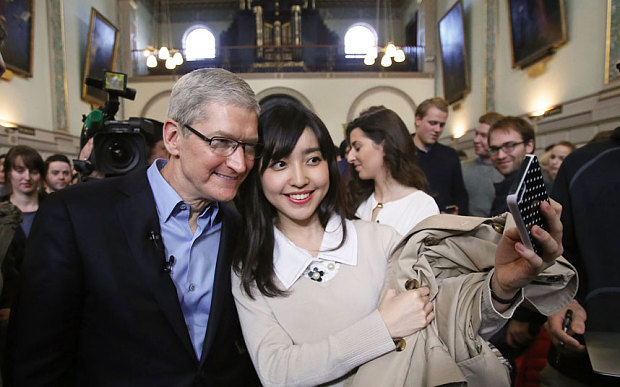 Apple chief executive Tim Cook (left) poses for selfies with students at Trinity College in Dublin. PHOTO: THE TELEGRAPH