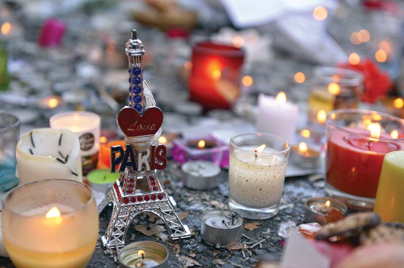 Candles and a miniature Eiffel Tower are placed at a memorial near the Bataclan concert hall. PHOTO: AFP