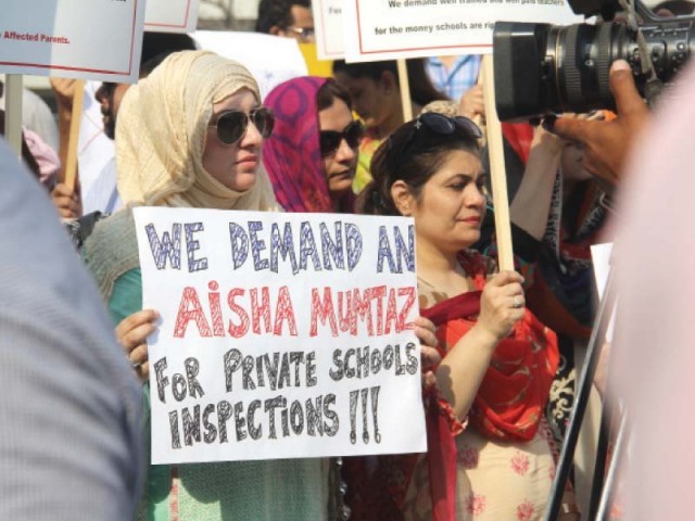 The protesters holding placards against fee hike. PHOTO: AYESHA MIR/EXPRESS