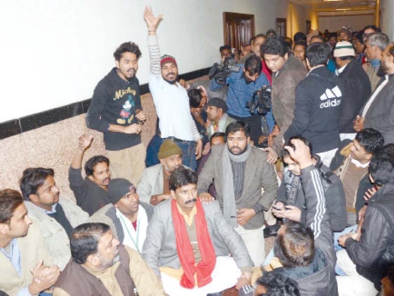 Paramedics  stage a sit-in at the OPD in Services Hospital. PHOTO/EXPRESS