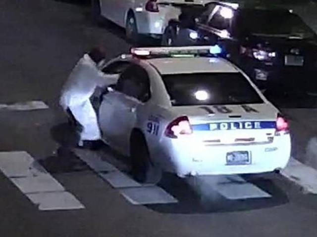 This image obtained January 8, 2016 from the Philadelphia Police Department, shows a suspect shooting into a police car on January 7, 2016. PHOTO: AFP