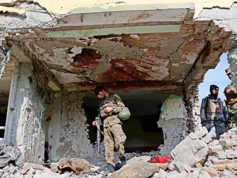 Security personnel inspect a building used by insurgents to launch the attack. PHOTO: AFP