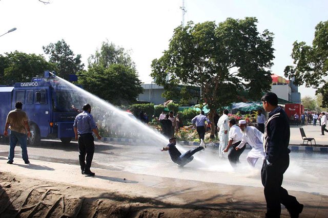 Police deploy water cannon to disperse workers of the Pakistan International Airlines during a protest rally against the planned privatisation of the national carrier at Karachi's Jinnah International Airport on February 02, 2015. PHOTO: ONLINE