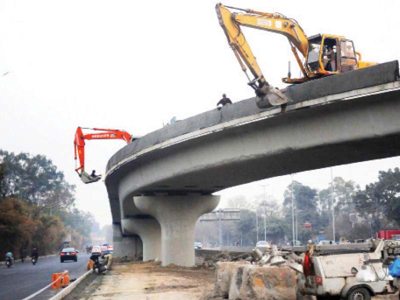 Crane operators busy in work at the flyover. PHOTO: WIRES