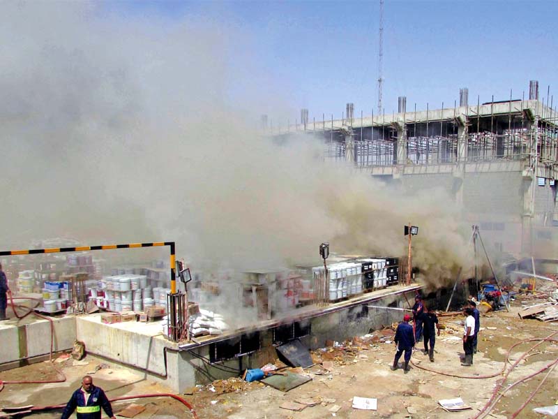 Several workers fell unconscious due to the clouds of smoke that engulfed the area surrounding the factory. 
PHOTO: MOHAMMAD AZEEM/EXPRESS