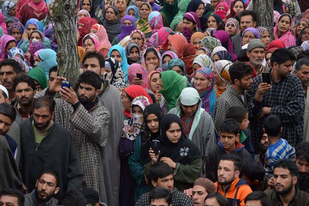 In this photograph taken on April 6, 2016, Kashmiri villagers gather during the funeral of suspected militant Bilal Ahmed Bhat in the village of Karimabad in Pulwama district, south of Srinagar. PHOTO: AFP