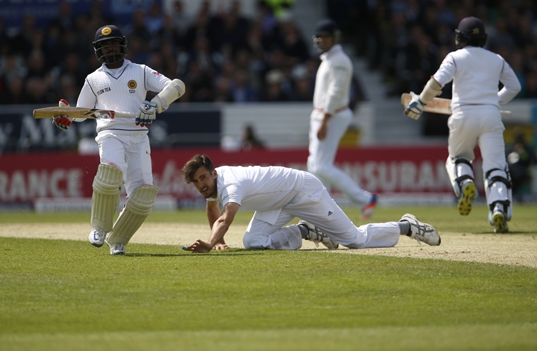 England's Steven Finn fails to stop a drive by Sri Lanka's Kusal Mendis. PHOTO: REUTERS