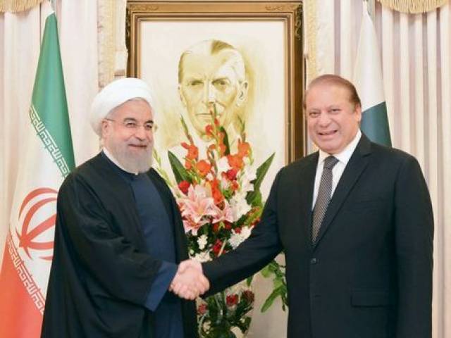 Prime Minister Nawaz Sharif shakes hands with Iranian President Hasan Rowhani. PHOTO: AFP