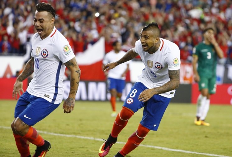 Chile midfielder Arturo Vidal (8) celebrates his penalty kick goal in extra time with forward Eduardo Vargas (11) during the second half of Chile's 2-1 win over Bolivia in the group play stage of the 2016 Copa America Centenario at Gillette Stadium on June 10, 2016. PHOTO: REUTERS