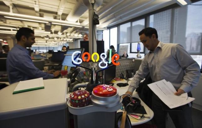 A neon Google logo is seen as employees work at the new Google office in Toronto, November 13, 2012. PHOTO: REUTERS