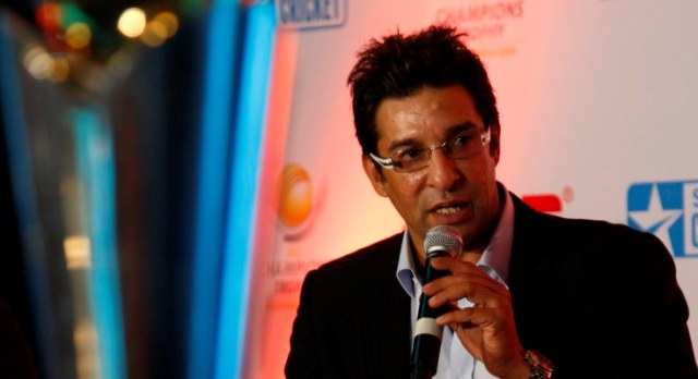Former Pakistani cricketer Wasim Akram talks about the upcoming ICC Champions Trophy, in New Delhi, India, Thursday, Sept. 17, 2009. On the left is the trophy that will be handed out to the winner. PHOTO: AFP