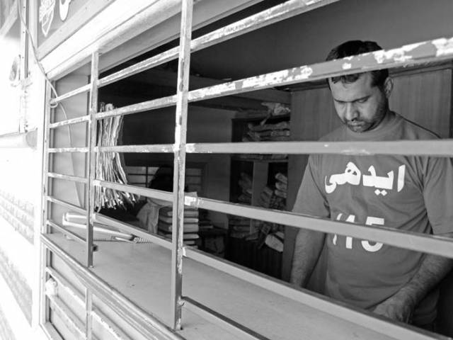 An attendant stands at the reception where people come to register bodies. PHOTO: AYESHA MIR/EXPRESS