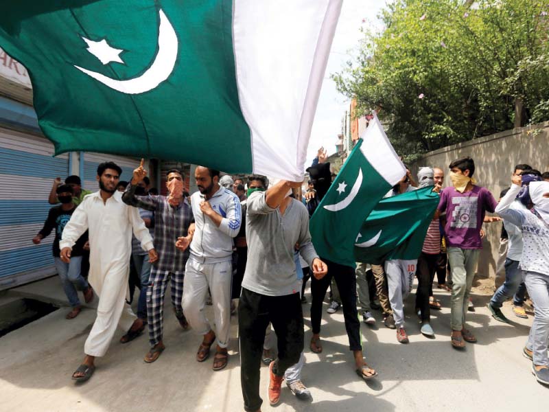 Protesters wave Pakistani flags in Srinagar. PHOTO: REUTERS