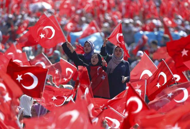 People wave Turkey's national flags during the Democracy and Martyrs Rally, organized by Turkish President Tayyip Erdogan PHOTO: REUTERS