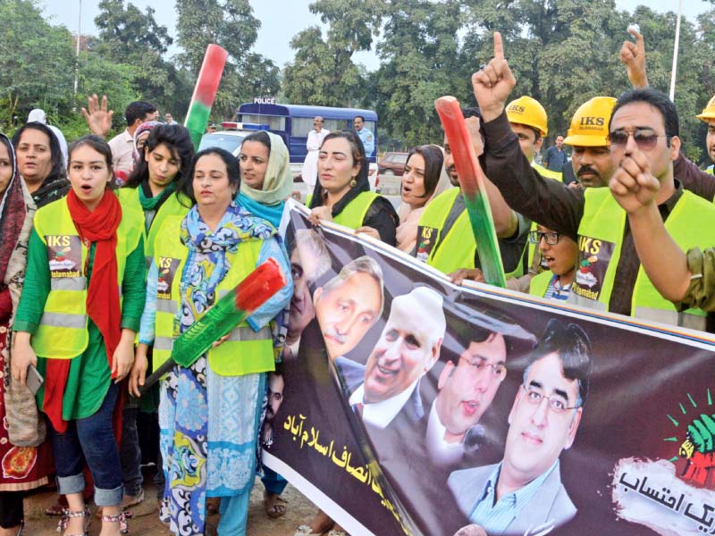 PTI supporters pose for a photo before their departure from Islamabad on Thursday for the public rally at Raiwind near Lahore. PHOTO: EXPRESS