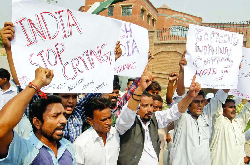 Members of the Hindu community chant slogans against the Indian government during a protest in Peshawar. PHOTO: PPI