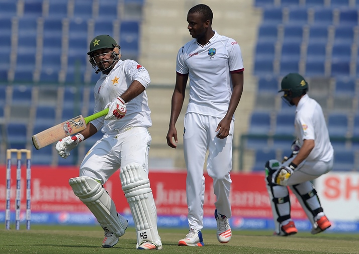 Pakistani batsman Sarfraz Ahmed (L) takes run next to the West Indies' bowler Miguel Cummins on the second day of the second Test between Pakistan and the West Indies at the Sheikh Zayed Cricket Stadium in Abu Dhabi on October 22, 2016.
PHOTO: AFP