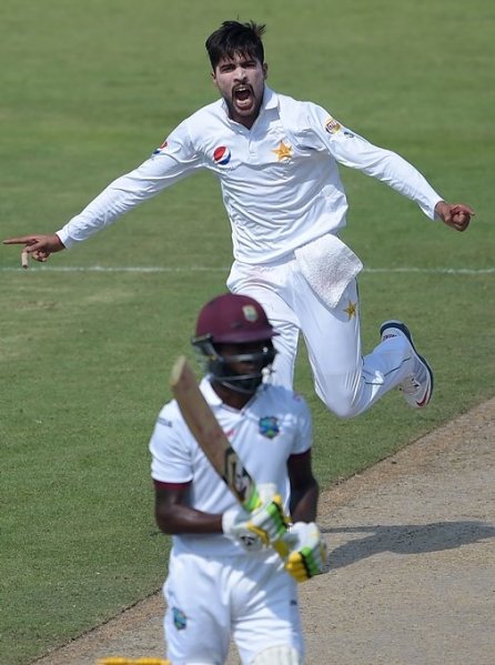 Pakistani bowler Mohammad Amir celebrates after taking the wicket of West Indies' batsman Jermaine Blackwood (front) on the second day of the third and final Test between Pakistan and West Indies at the Sharjah Cricket Stadium in Sharjah on October 31, 2016.
PHOTO: AFP