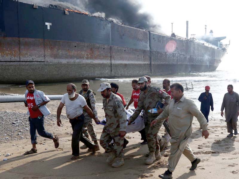 Emergency services gather around the wreckage of a burning ship after a gas cylinder explosion at the Gadani shipbreaking yard. PHOTO: INP