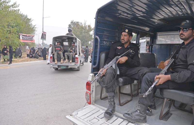 Security personnel escort a Chehlum procession in Islamabad. PHOTO: AFP