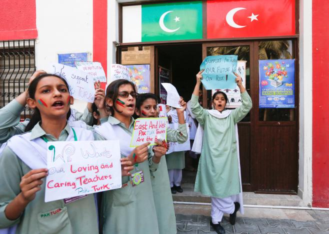 Students hold signs as they chant slogans during a protest on the premises of PAKTURK International Schools & Colleges in Karachi, Pakistan November 17, 2016. PHOTO: REUTERS