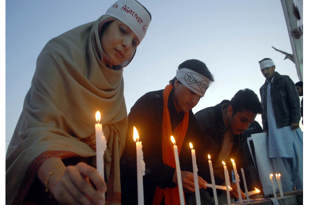 Members of Civil Society are enlightening candles in commemoration of martyrs of APS. PHOTO: PPI
