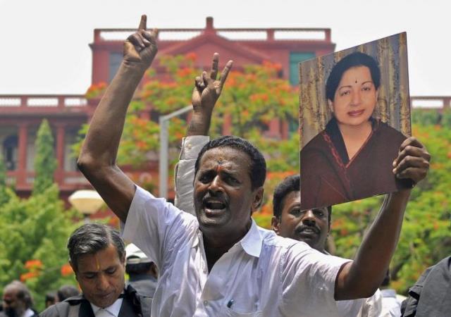Lawyers from the Karnataka High Court hold a portrait of Jayalalithaa Jayaram, chief minister of Tamil Nadu and chief of her AIADMK party, during celebrations outside a court in Bengaluru, India, May 11, 2015. PHOTO: REUTERS