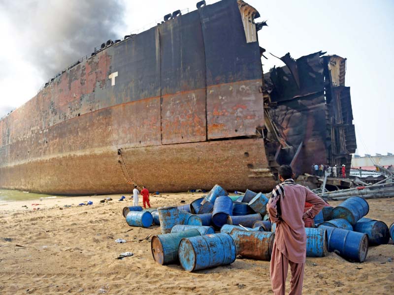 A man looks at the wreckage of the ship which caught fire at the Gadani ship-breaking yard on November 1. PHOTO: FILE