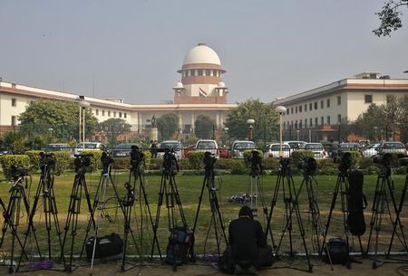 A television journalist sets his camera inside the premises of the Supreme Court in New Delhi. PHOTO: REUTERS