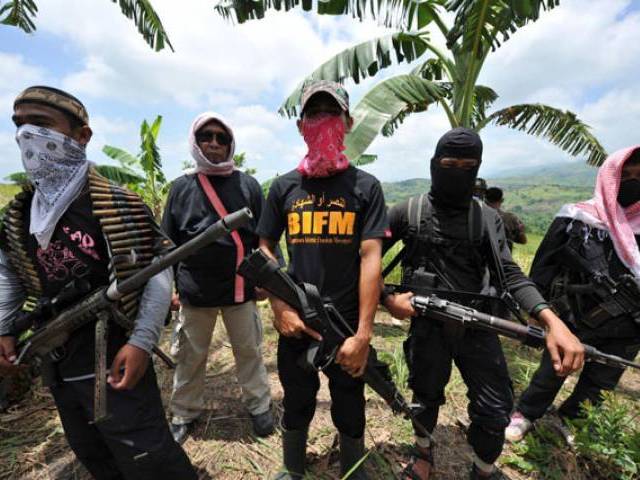 This file photo shows members of a breakaway Muslim separatist group stand guard during a clandestine press conference in the town of Datu Unsay, sothern Maguindanao province in the Philippines, on August 28, 2011. PHOTO: AFP