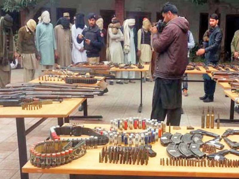 Police present the arrested suspects and the recovered weapons. PHOTO: INP
