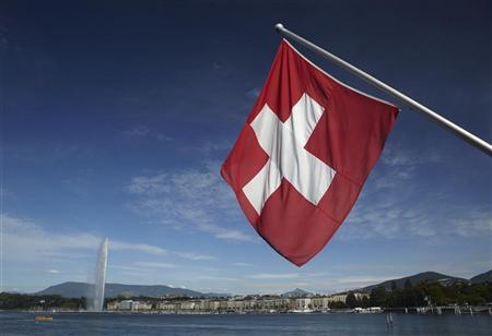 A Swiss flag is pictured next to the Jet d'Eau (water fountain), and the Lake Leman from the St-Pierre Cathedrale in Geneva June 5, 2012. PHOTO: REUTERS