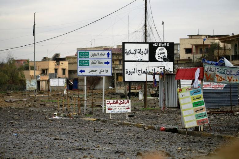 Islamic State signs are seen on a street during a battle between Iraqi forces and Islamic State militants, in Mosul, Iraq March 16, 2017. PHOTO: REUTERS