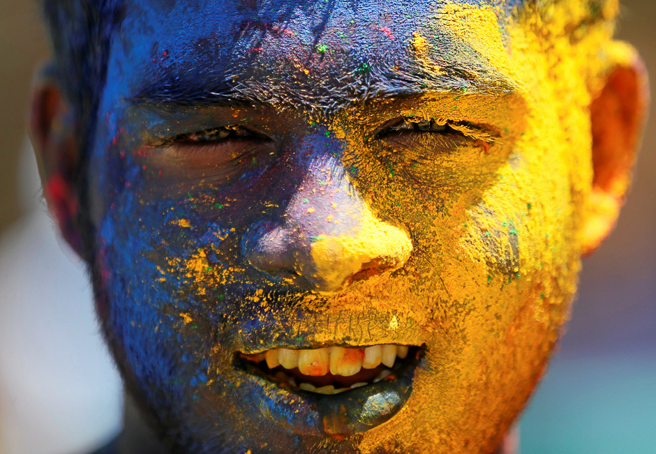 A boy with his face smeared in coloured powder, is seen during Holi, the Festival of Colours organised by " Colombo Indians", Indians who live in Colombo, in Colombo, Sri Lanka. PHOTO: REUTERS