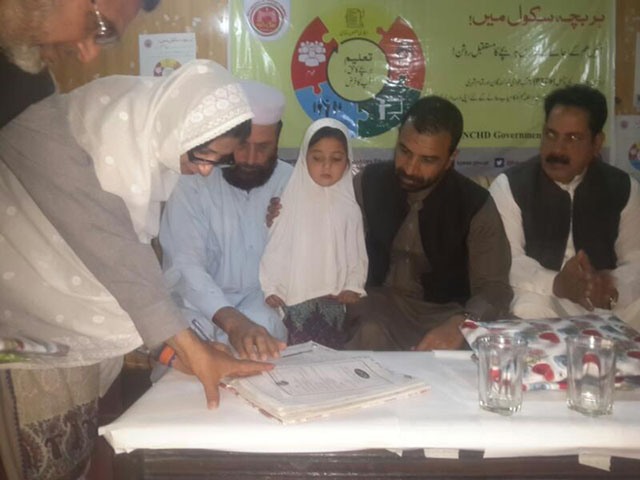 K-P MPA Ziaullah Bangash enrols in daughter in a public school to kick off province-wide enrollment drive. PHOTO: Asad Zia/EXPRESS
