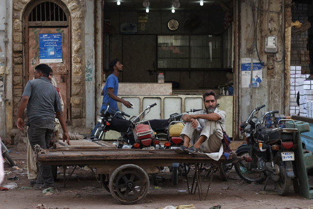 A labourer sits on his cart. PHOTO: FAWAD HASAN