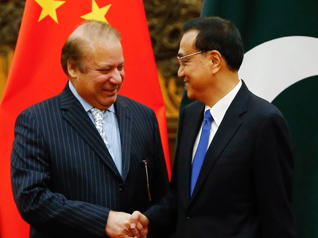 China's Premier Li Keqiang (R) and Pakistan's Prime Minister Nawaz Sharif shake hands during a signing ceremony at the Great Hall of the People in Beijing on May 13, 2017. PHOTO: AFP