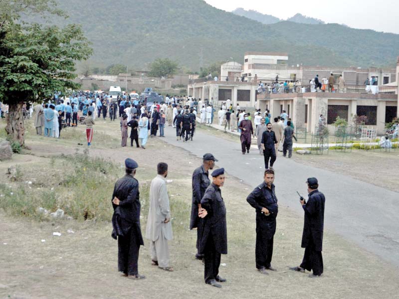 Police, backed by armoured personnel carriers, are present at QAU. PHOTO: MUDASSAR RAJA/EXPRESS