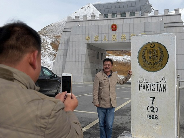 In this photograph taken on September 29, 2015, a Chinese national takes a photograph of his colleague at the Pak-China Khunjerab Pass, the world's highest paved border crossing at 4,600 metres above sea level. PHOTO: AFP