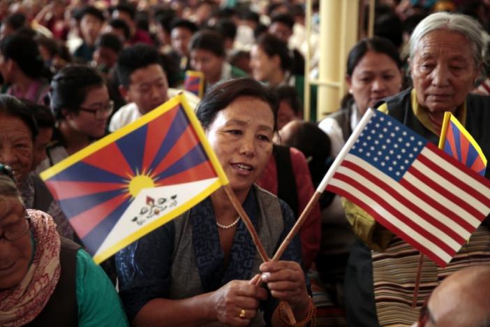 A Tibetan refugee holds flags at a function for visiting U.S. delegates in Dharamsala, the seat of the Dalai Lama, in India. PHOTO: REUTERS