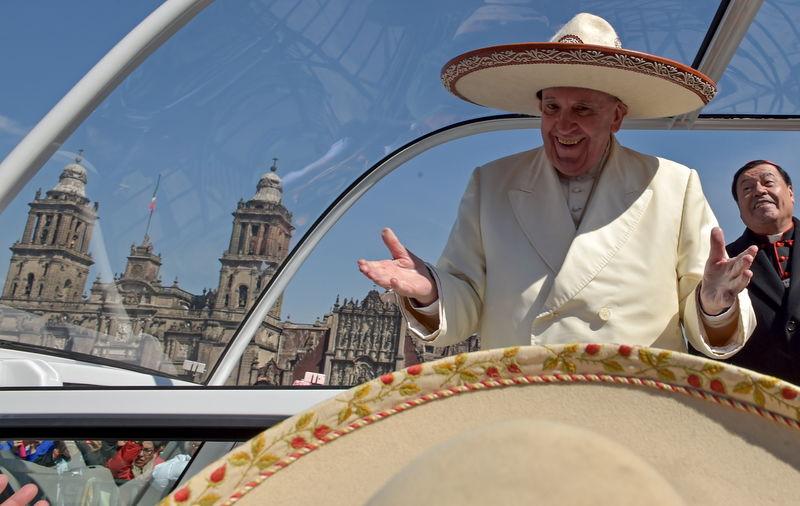 Pope Francis gestures while wearing a Mariachi hat given to him by someone in the crowd on Zocalo Square in Mexico City. PHOTO: REUTERS
