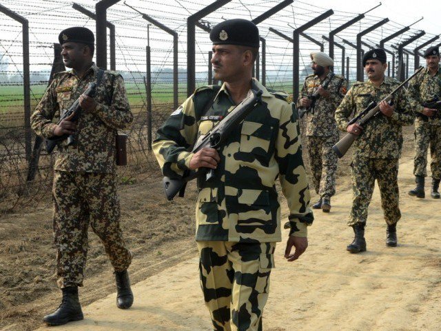Indian Border Security Force soldiers patrol along the India-Pakistan border fence about 27 KM from Wagah on January 13, 2013. PHOTO: AFP