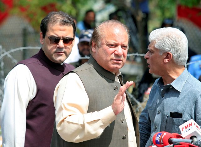 Prime Minister Nawaz Sharif waves as his son, Hussain Nawaz looks on. PHOTO: REUTERS / FILE