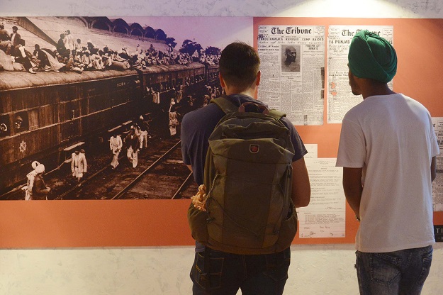 Visitors look at photographs and newspaper clippings at the Partition Museum in Amritsar, India. PHOTO: AFP